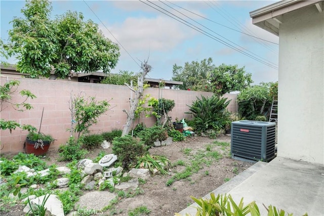 view of yard featuring a fenced backyard and central air condition unit