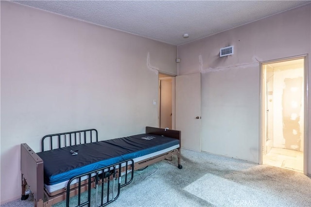living area featuring a textured ceiling, visible vents, and carpet
