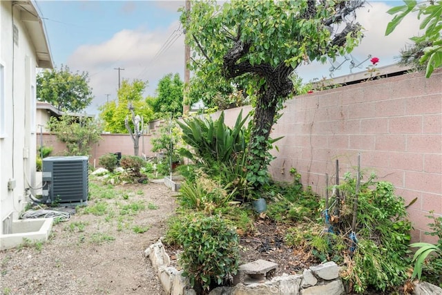 view of yard featuring central air condition unit and a fenced backyard
