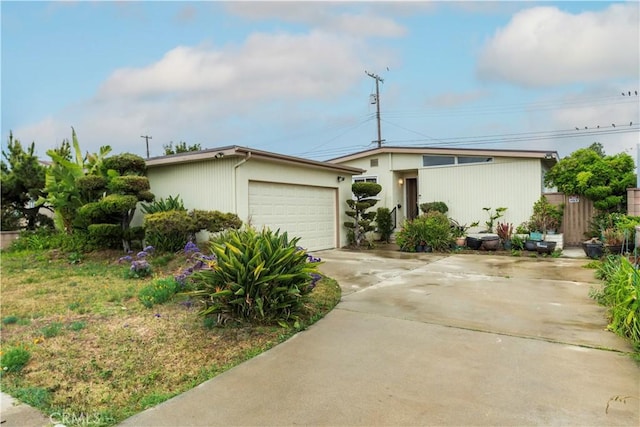 mid-century modern home with an attached garage and driveway