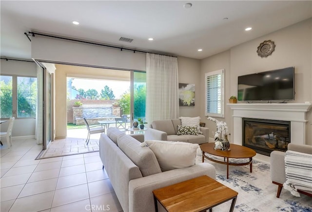 54 Rim Crst, Irvine, CA 92602 - living room with recessed lighting, plenty of natural light, a glass covered fireplace, and baseboards
