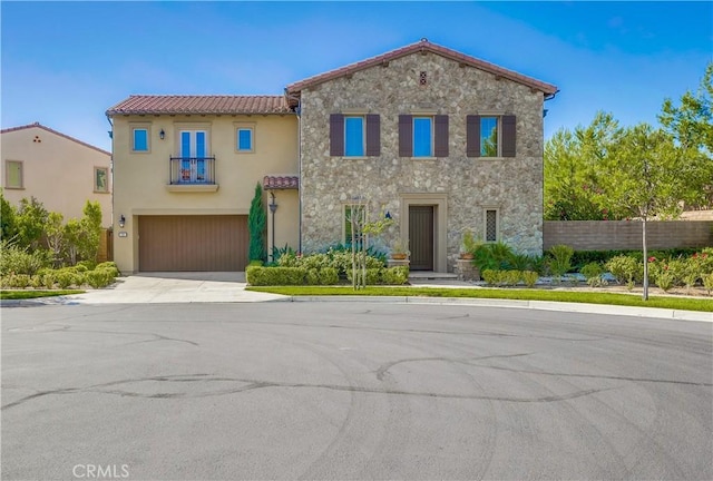 54 Rim Crst, Irvine, CA 92602 - mediterranean / spanish-style home with a tiled roof, stucco siding, stone siding, an attached garage, and concrete driveway