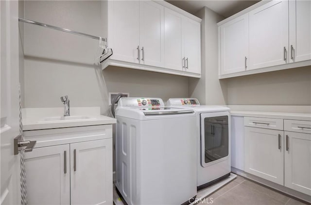 54 Rim Crst, Irvine, CA 92602 - clothes washing area featuring light tile patterned flooring, washer and clothes dryer, a sink, and cabinet space