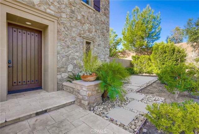 54 Rim Crst, Irvine, CA 92602 - view of exterior entry featuring fence and stone siding