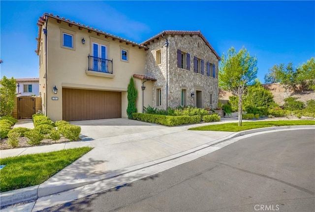54 Rim Crst, Irvine, CA 92602 - mediterranean / spanish home featuring an attached garage, concrete driveway, stucco siding, and a tile roof