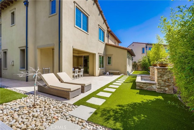 54 Rim Crst, Irvine, CA 92602 - rear view of house with a patio area, a yard, and stucco siding