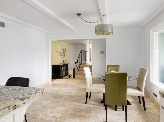 dining room with visible vents, beamed ceiling, and stairs