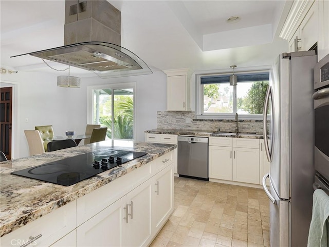 kitchen featuring a sink, a healthy amount of sunlight, island exhaust hood, and stainless steel appliances