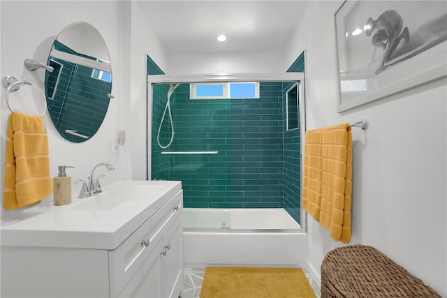 bathroom with vanity and bath / shower combo with glass door
