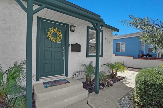 property entrance with stucco siding
