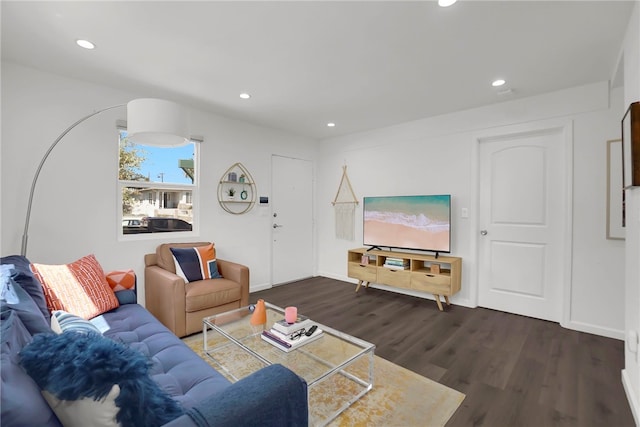 living area with recessed lighting, dark wood-type flooring, and baseboards