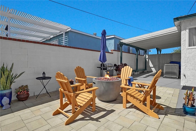 view of patio / terrace with central AC, a grill, a fire pit, a pergola, and a fenced backyard