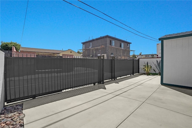view of gate with a patio and fence