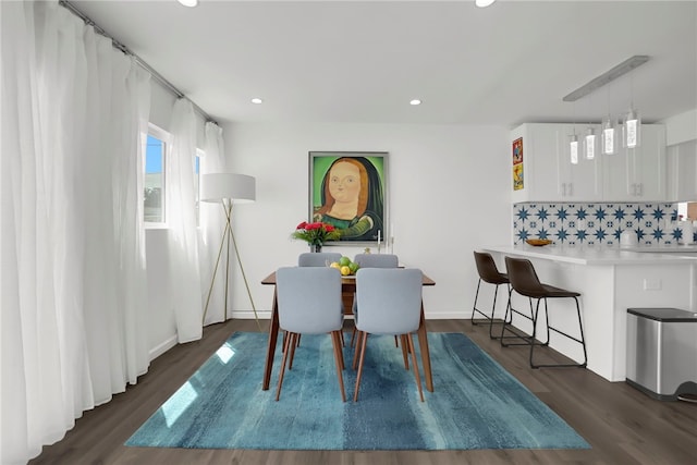 dining room with recessed lighting, dark wood-type flooring, and baseboards