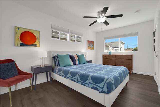bedroom featuring dark wood-style floors, baseboards, and ceiling fan