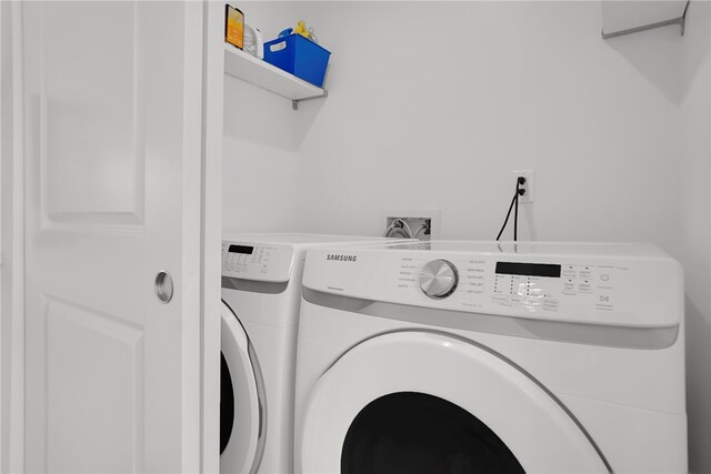 laundry area with laundry area and separate washer and dryer