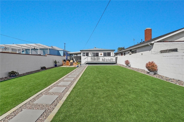 back of house with fence and a lawn