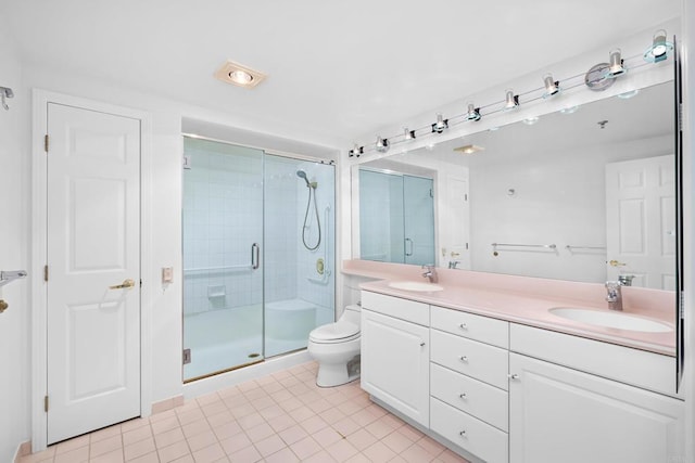 full bathroom featuring a shower stall, toilet, a sink, and double vanity