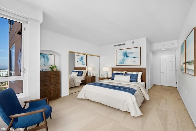 bedroom featuring light colored carpet, baseboards, and visible vents