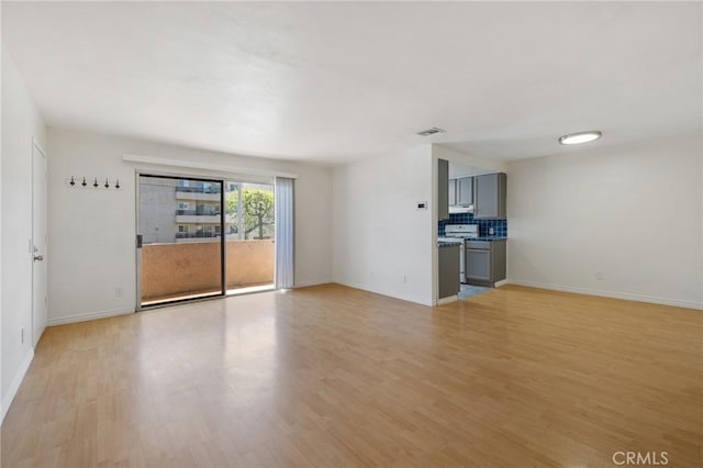 5055 Coldwater Canyon Ave Unit 105, Sherman Oaks, CA 91423 - unfurnished living room with baseboards and light wood-type flooring