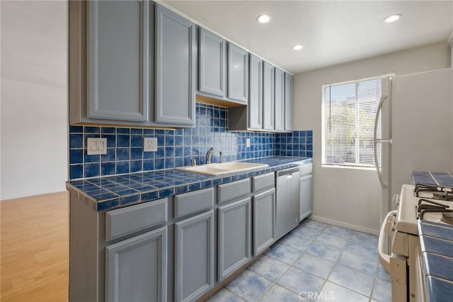 5055 Coldwater Canyon Ave Unit 105, Sherman Oaks, CA 91423 - kitchen with stainless steel dishwasher, a sink, gray cabinetry, white gas range, and tasteful backsplash