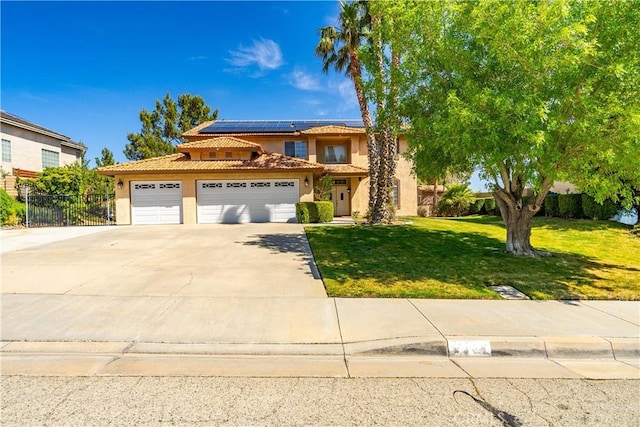 traditional-style home featuring stucco siding, driveway, a front yard, a garage, and fence