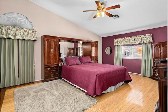 bedroom featuring visible vents, ceiling fan, vaulted ceiling, and light wood-style flooring
