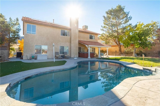 outdoor pool with a patio area, central AC unit, fence, and a hot tub