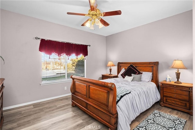 bedroom featuring wood finished floors, ceiling fan, and baseboards