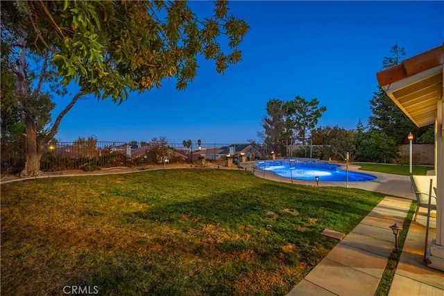 view of yard with an outdoor pool and a fenced backyard