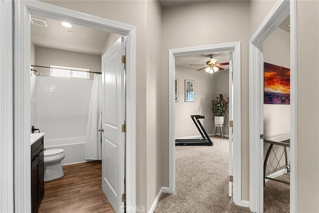hall with visible vents and baseboards