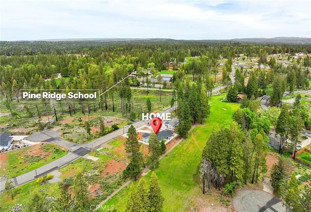 drone / aerial view featuring a forest view