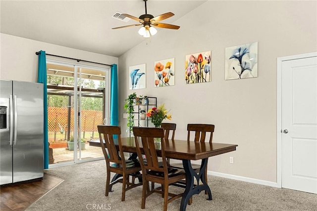 dining space with carpet flooring, baseboards, vaulted ceiling, and a ceiling fan