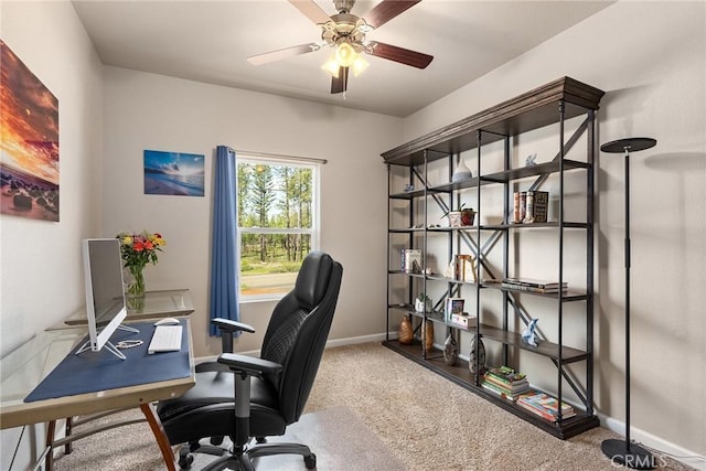 carpeted office space with baseboards and ceiling fan