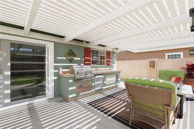 balcony featuring a pergola, a grill, and an outdoor kitchen