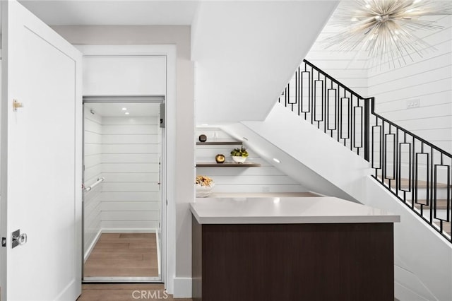 interior space featuring baseboards, stairway, and wood finished floors