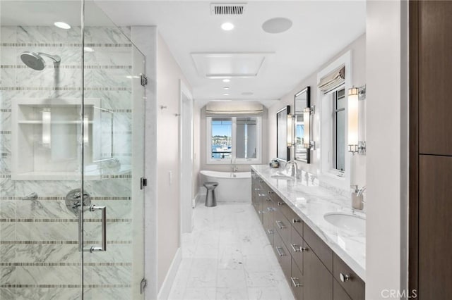 bathroom featuring a soaking tub, a shower stall, visible vents, marble finish floor, and a sink