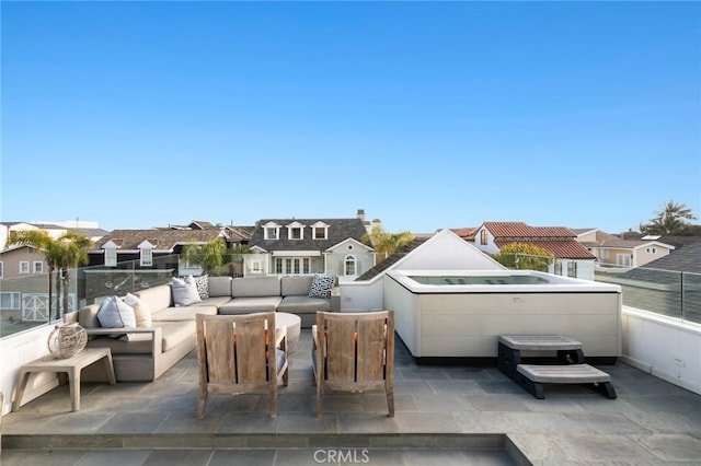 view of patio with an outdoor living space, a residential view, and a hot tub