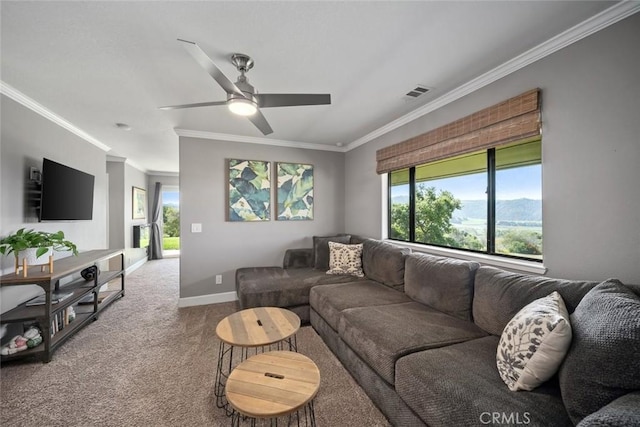 carpeted living room with crown molding, baseboards, visible vents, and a wealth of natural light