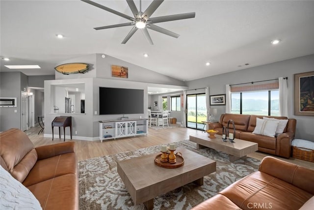 living area with light wood-style floors, a ceiling fan, lofted ceiling, and recessed lighting