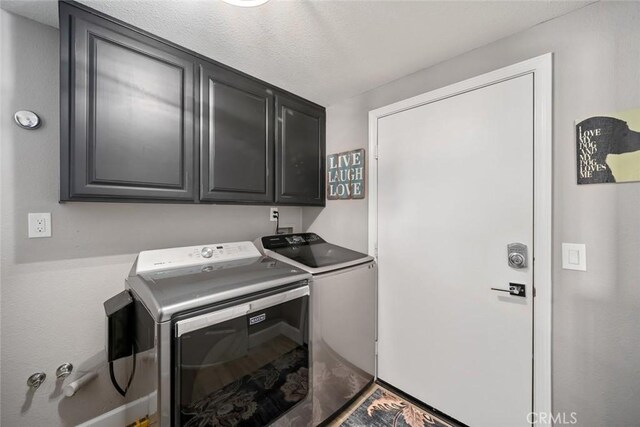 laundry area featuring washer and dryer and cabinet space