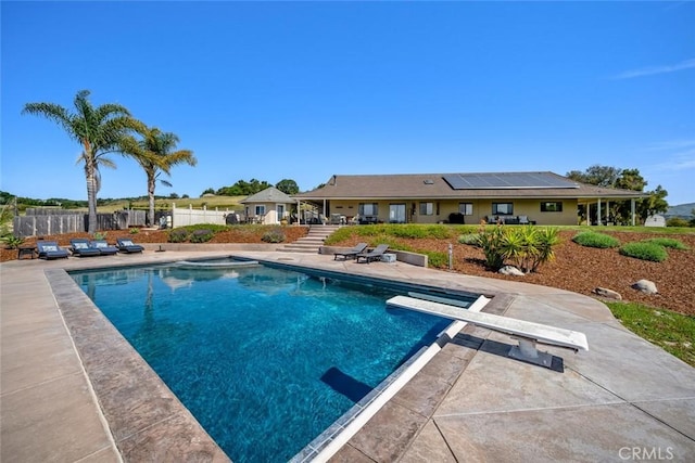view of pool featuring a diving board, a patio area, a fenced in pool, and fence