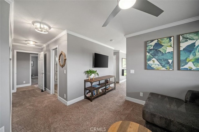 carpeted living area with ornamental molding, ceiling fan, and baseboards