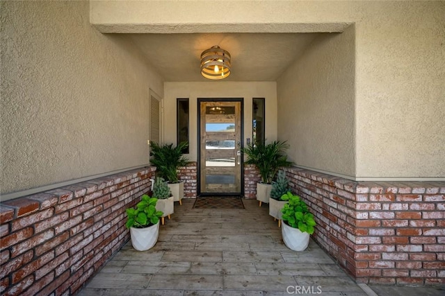 entrance to property with stucco siding