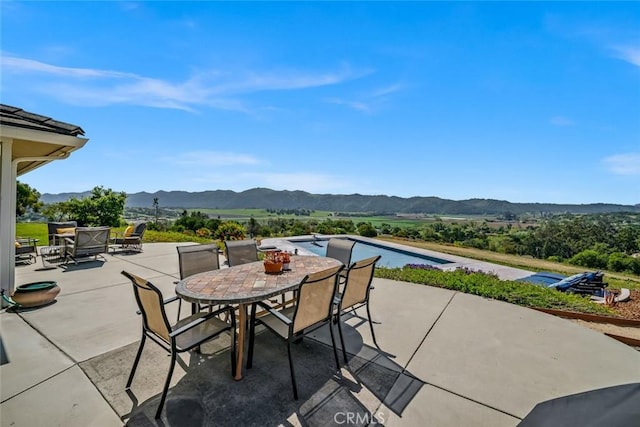 view of patio featuring a mountain view and outdoor dining area