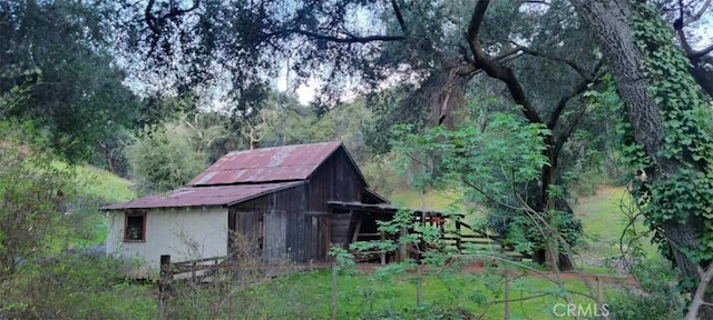 view of barn featuring a forest view