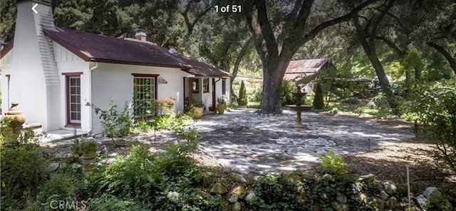 view of property exterior featuring stucco siding and a chimney