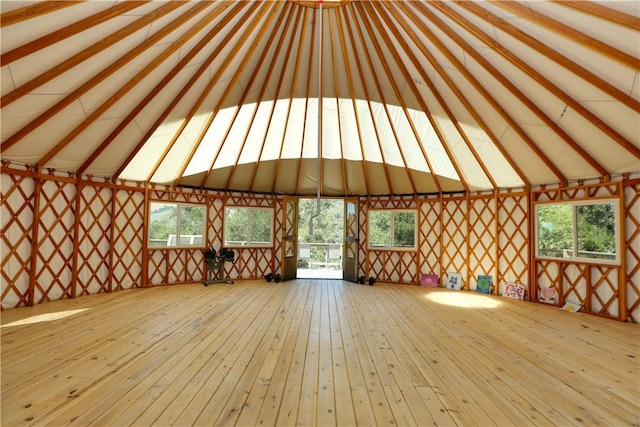 unfurnished sunroom featuring beam ceiling and a healthy amount of sunlight