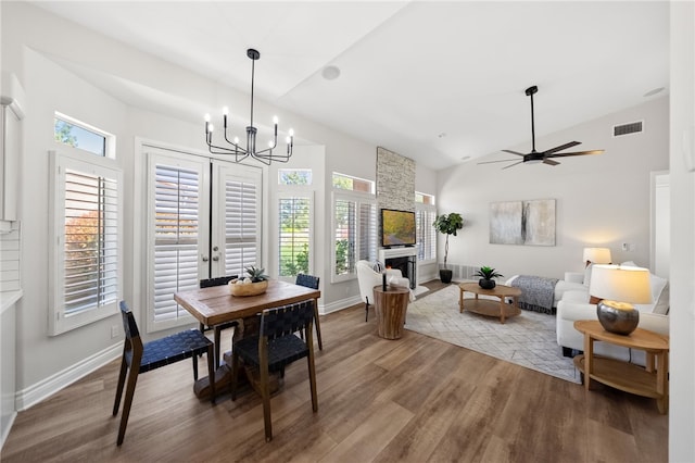 38027 Cherrywood Dr, Murrieta, CA 92562 - dining area featuring wood finished floors, a fireplace, a chandelier, ceiling fan, and high vaulted ceiling