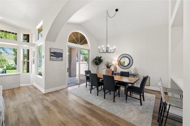 38027 Cherrywood Dr, Murrieta, CA 92562 - dining room featuring lofted ceiling, wood finished floors, a chandelier, and arched walkways